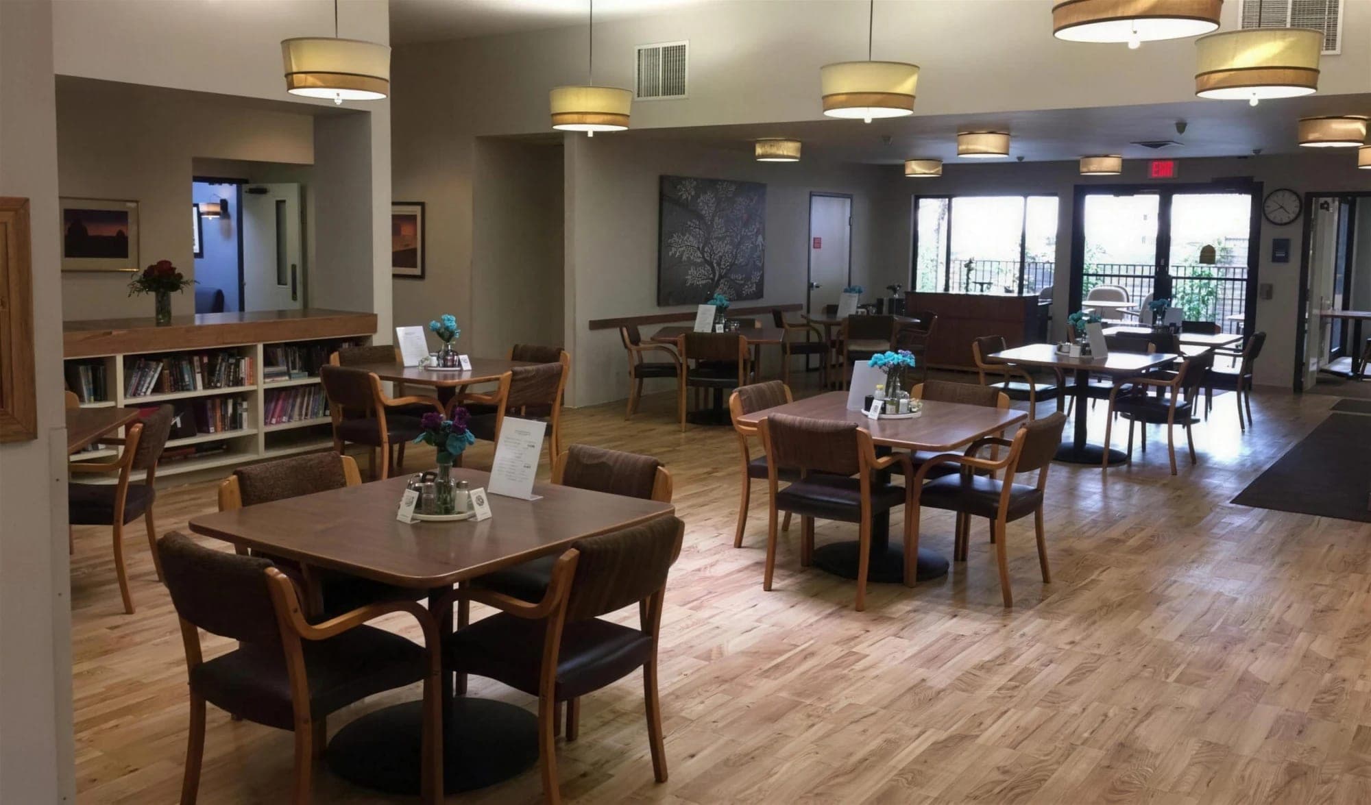 The dining room with family-style tables and a library nook at Madison House in Cortez, Colorado